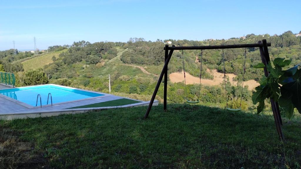 uma vista para uma piscina num campo relvado em Quinta do Oratório Agroturismo em Óbidos