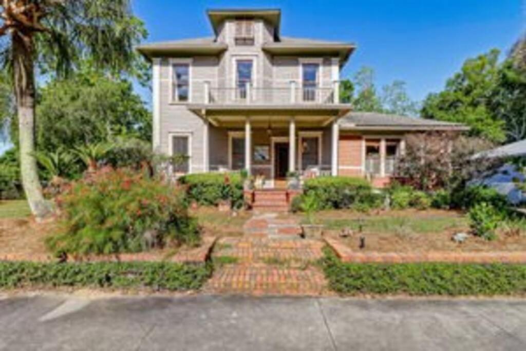 a large house with a porch and a driveway at Island Charm1908 classic in the heart of downtown in Fernandina Beach