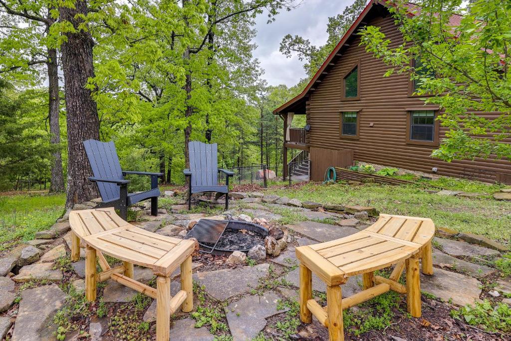 two chairs and a fire pit in front of a house at Beaver Lake Vacation Rental with Private Hot Tub! in Eureka Springs