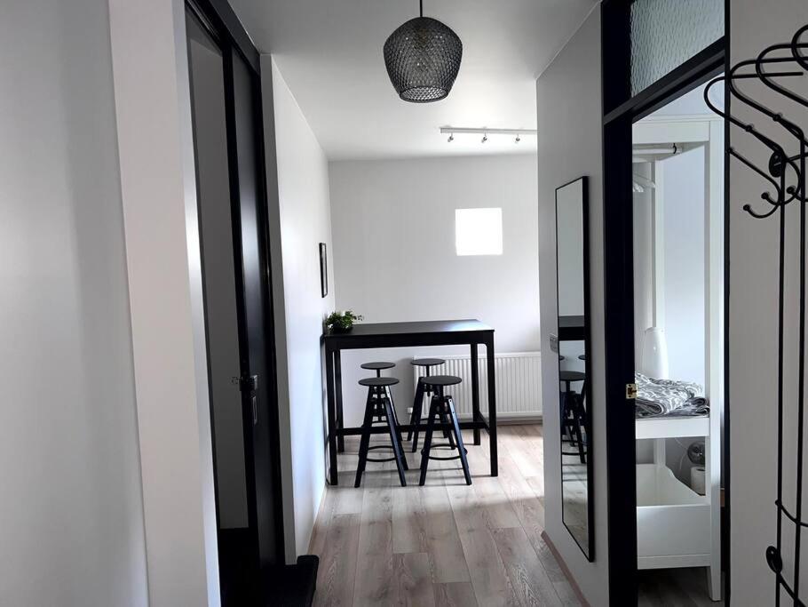 a hallway with two stools and a table in a room at Lovely Apartment with 2-bedrooms and living room for 4 guests, max 6 - Seaside Neighborhood in Reykjavík