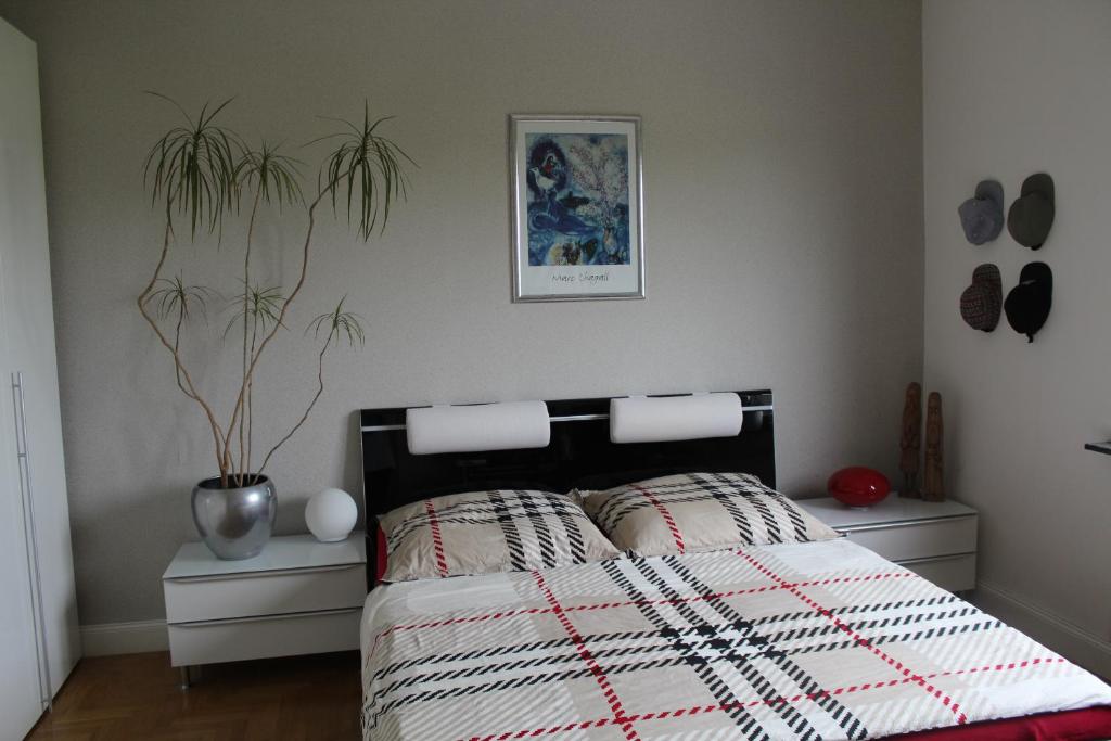 a bedroom with a bed with a red and white quilt at Privatzimmer Boardinghouse/Messe Düsseldorf in Viersen