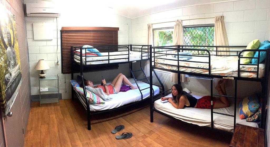 two girls laying on bunk beds in a room at Mission Beach Retreat in Mission Beach