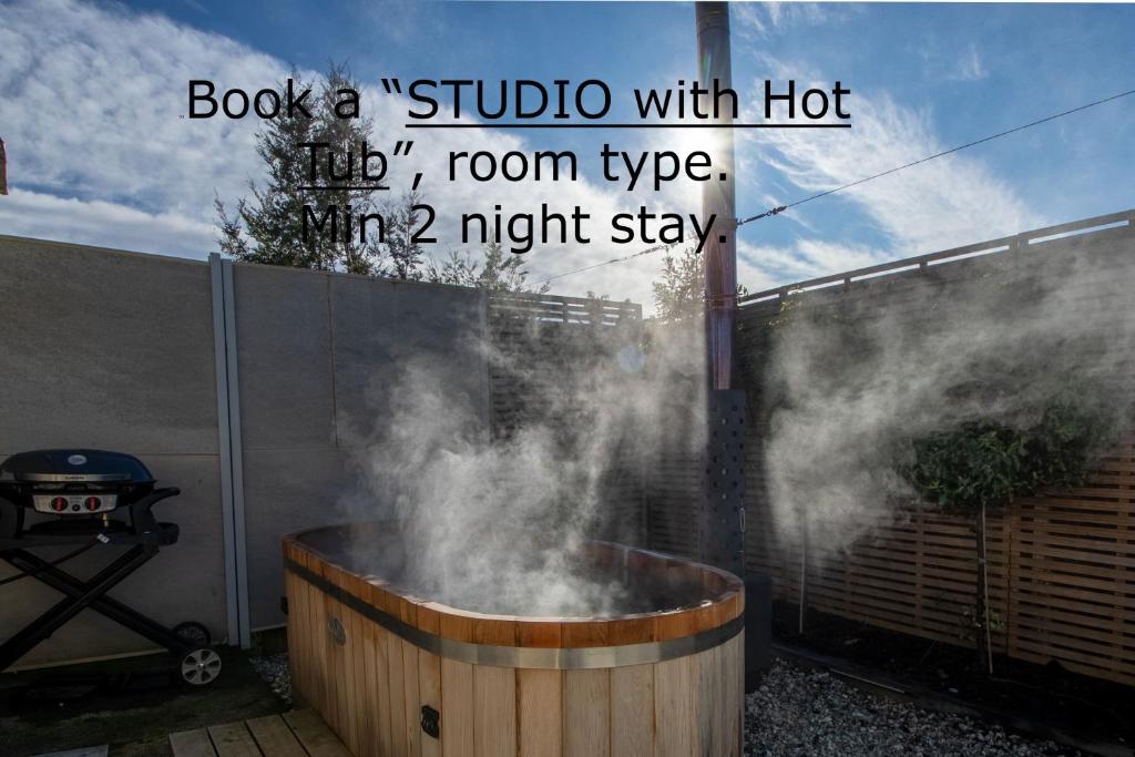 a hot tub with smoke coming out of it at Anchorage Motel Apartments in Te Anau