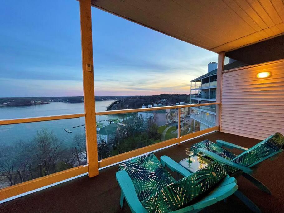 a balcony with two chairs and a view of the water at Rare GEM @Emerald Bay - Smart Home - THAT VIEW!!! in Lake Ozark