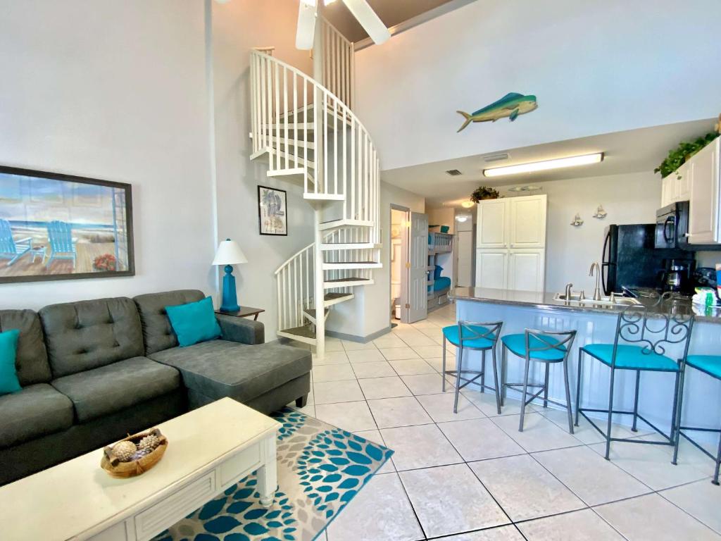 a living room with a couch and a kitchen at Grand Caribbean 419 by ALBVR - New Owner - Great location in Orange Beach