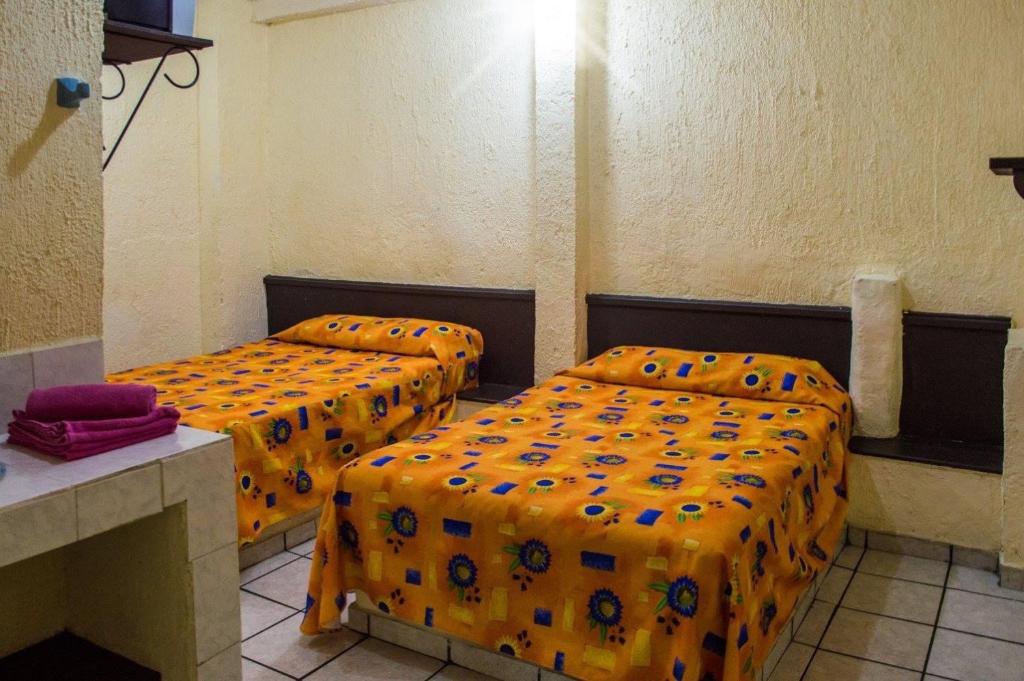 Postel nebo postele na pokoji v ubytování Hotel Jorges Morelia