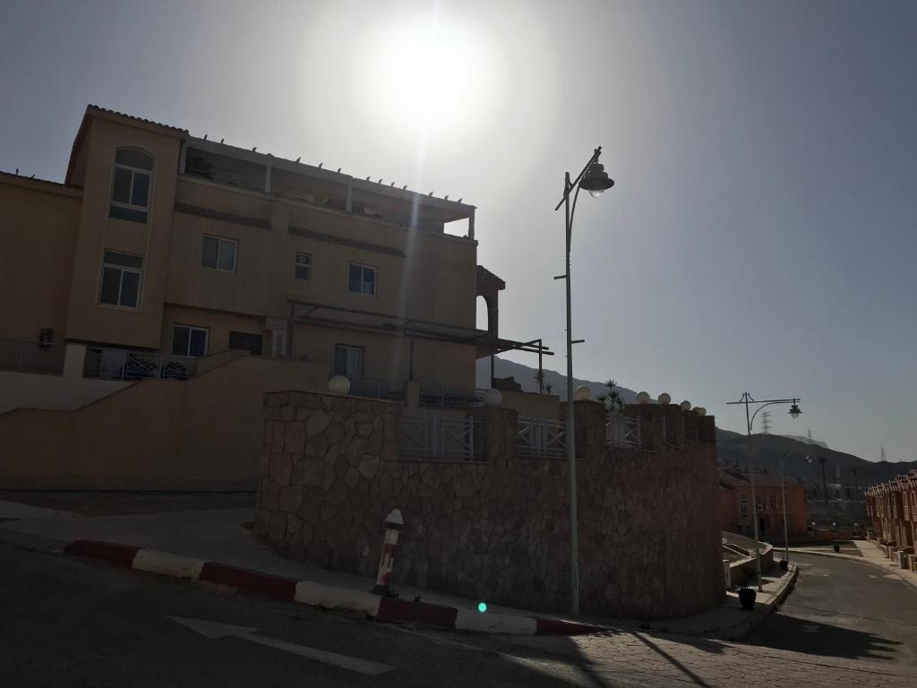 a building with a street light in front of a building at Porto sokhna in Ain Sokhna