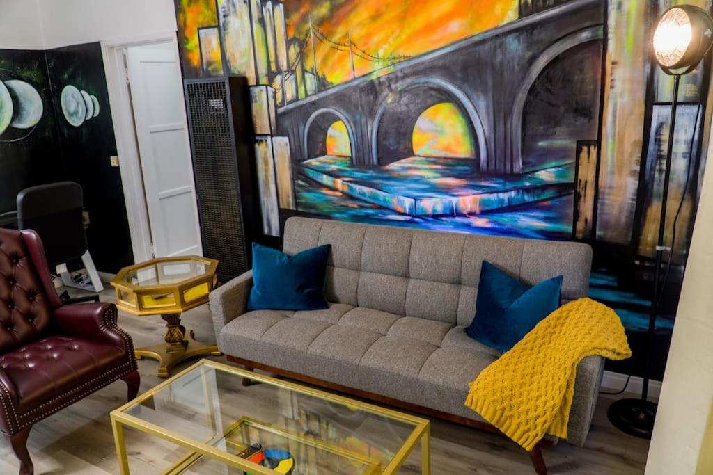 a living room with a couch and a painting at Artful Retreat - King Bed, Work Desk, WIFI, Unique Murals, Perfect for Business Travelers, Downtown & Near Universal Studios in Burbank