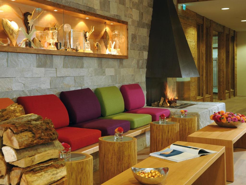 a living room with a couch and a fireplace at Hotel Fire & Ice Düsseldorf/Neuss in Neuss