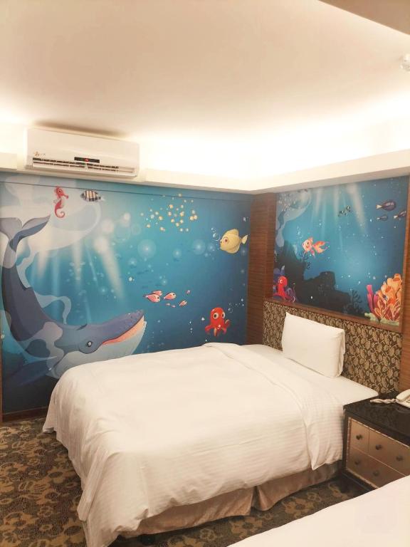 a bedroom with an under the sea mural at JinShan Sakura Bay Hot Spring Hotel in Jinshan