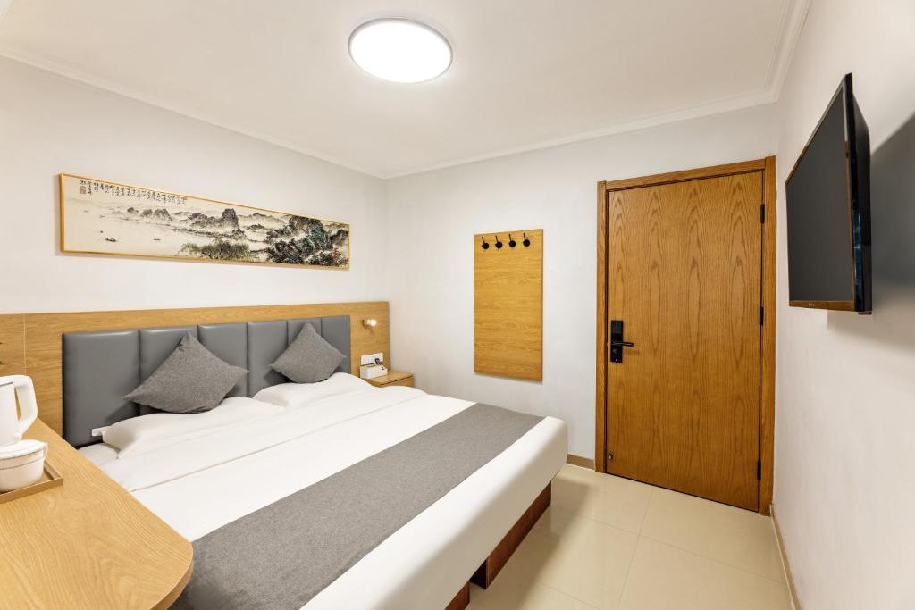 Postel nebo postele na pokoji v ubytování Happy Dragon Hotel -- Nearby Tiananmen square & Forbidden City & Wangfujing Street & Line 5,6,8 Subway Nearby & Free coffee & Free laundry & Fluent English speaking & Tourist attractions ticket service & Free WiFi unlimited for Western software