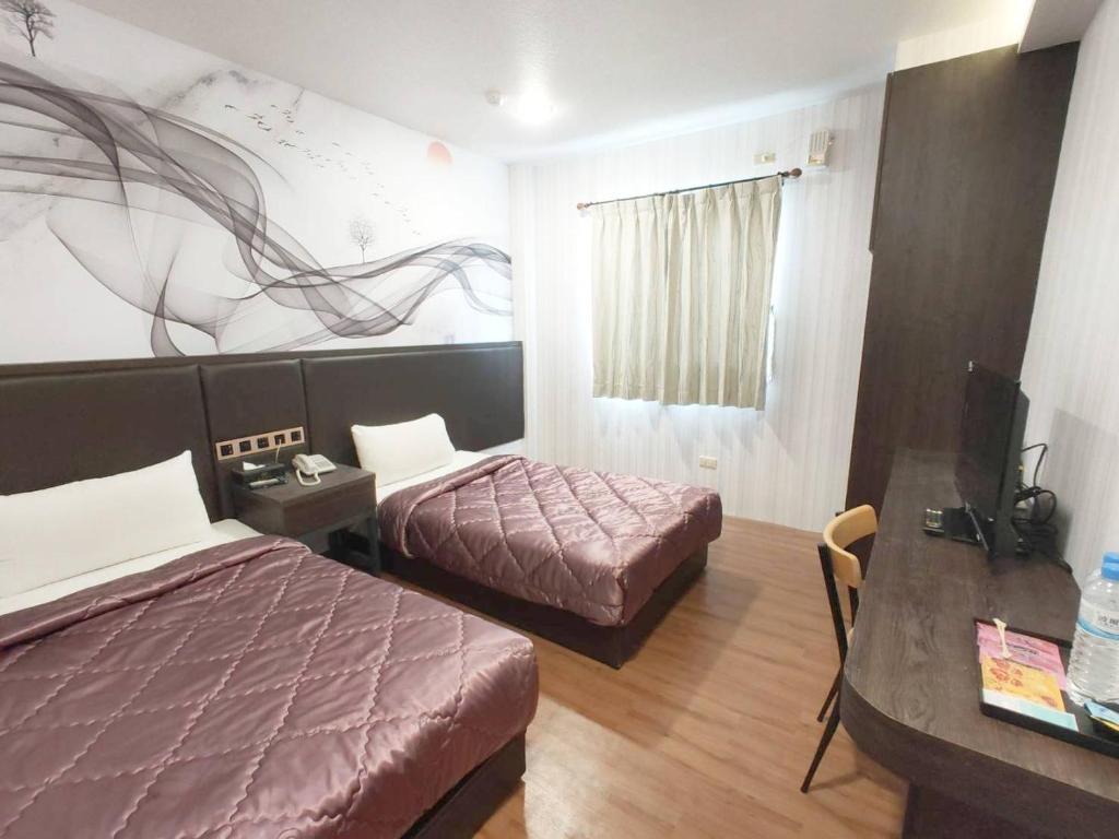 Postel nebo postele na pokoji v ubytování Royal Business Hotel