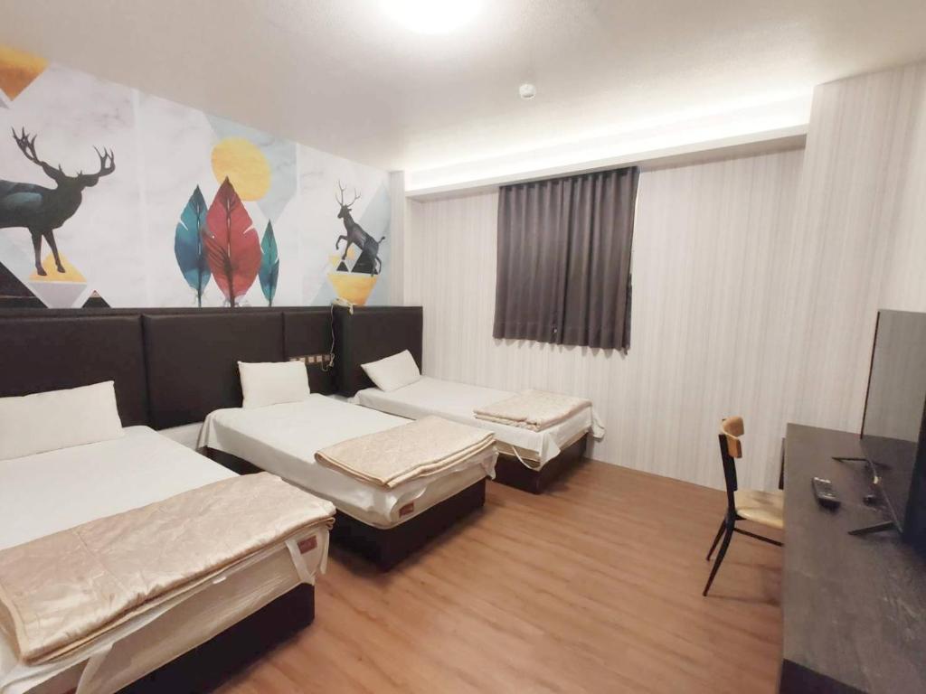 Postel nebo postele na pokoji v ubytování Royal Business Hotel