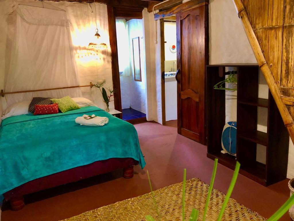 Postel nebo postele na pokoji v ubytování Hostal Los Orishas