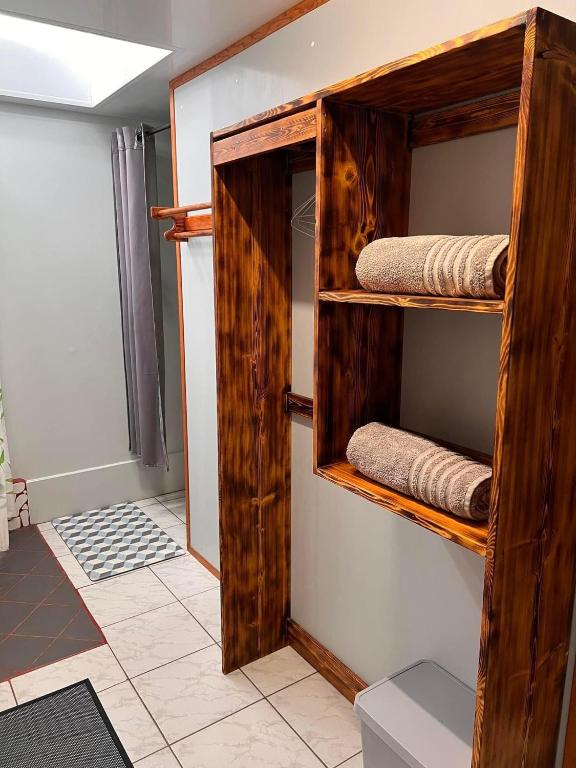 a room with wooden shelves with folded towels at Moorea Vaiare Lodge in Moorea