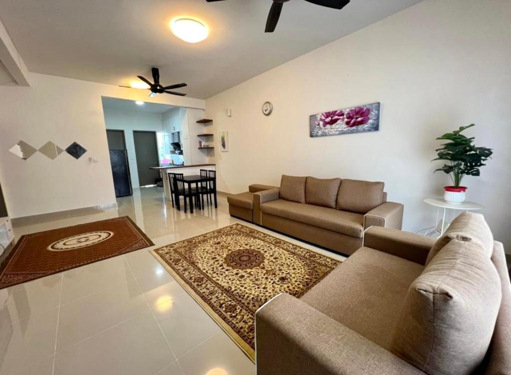 a living room with a couch and a table at Homestay Ika KLIA @ Enstek in Kampong Chinchang