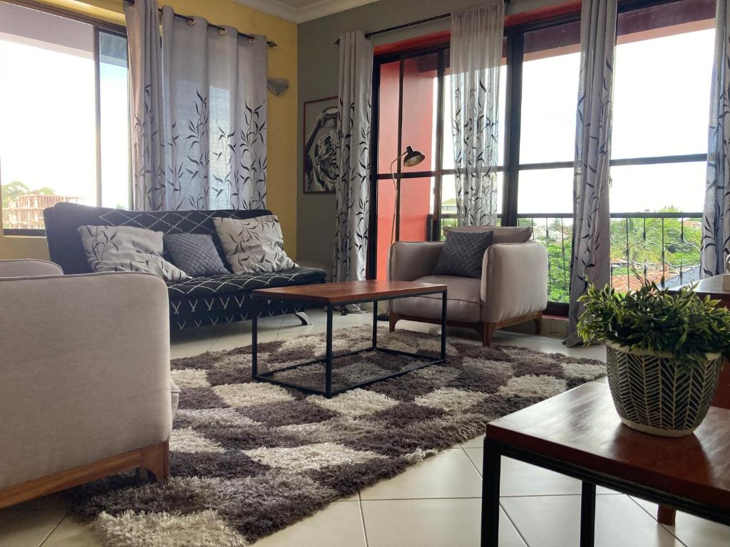 a living room with a couch and a table at the bib By Jevas in Dar es Salaam