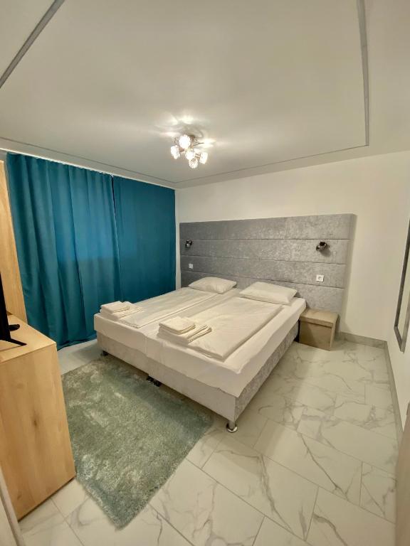 A bed or beds in a room at Q-Panzió
