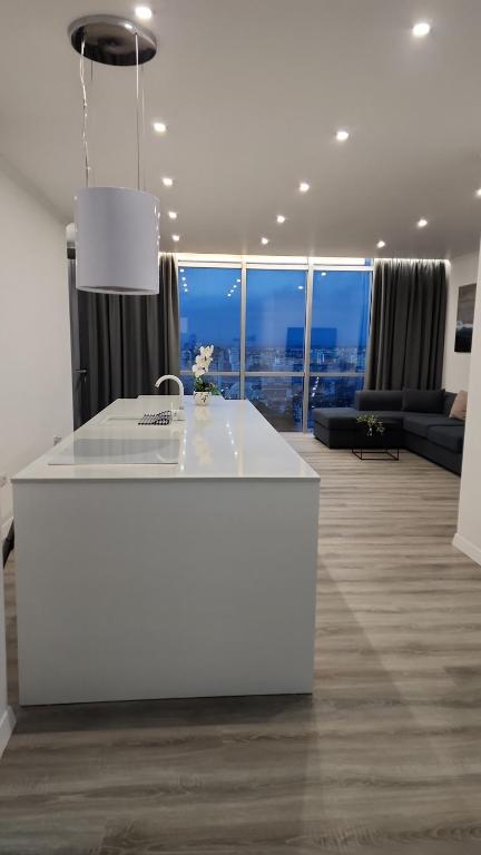 a white island in a living room with a view at Durres City Apartment, City center & close to the beach in Durrës