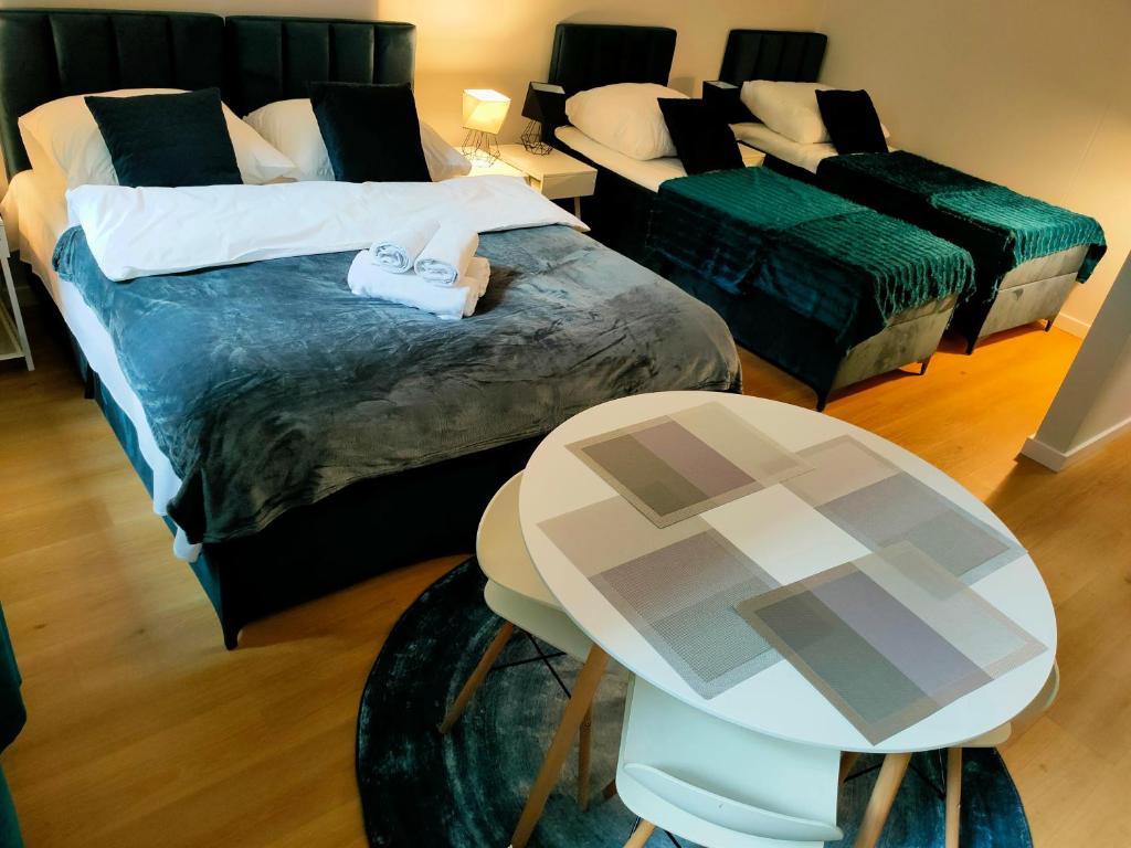 Postel nebo postele na pokoji v ubytování Hugo Eden Apartments