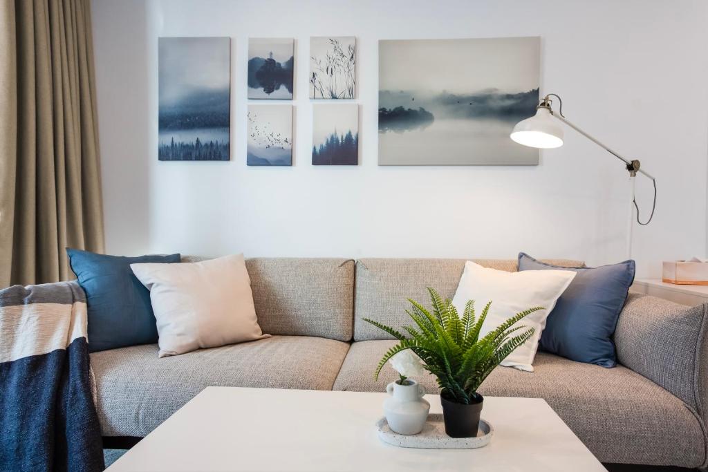 a living room with a couch and a table at Panorama Apartment Walk to Box Hill Central by GoodLive in Box Hill