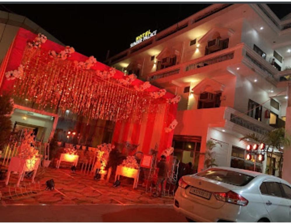 a building with red curtains in front of it at Hotel Sunder Palace, Dehradun in Dehradun
