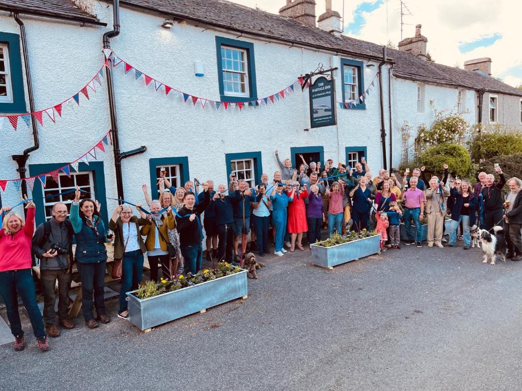 un grande gruppo di persone che si trovano fuori da un edificio di The Mardale Inn a Penrith