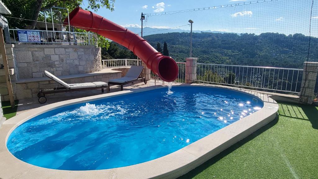 a plunge pool with a slide in a backyard at Holiday Home Gustirna in Selca