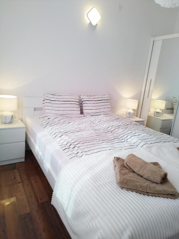 Postel nebo postele na pokoji v ubytování Apartmani ZAT