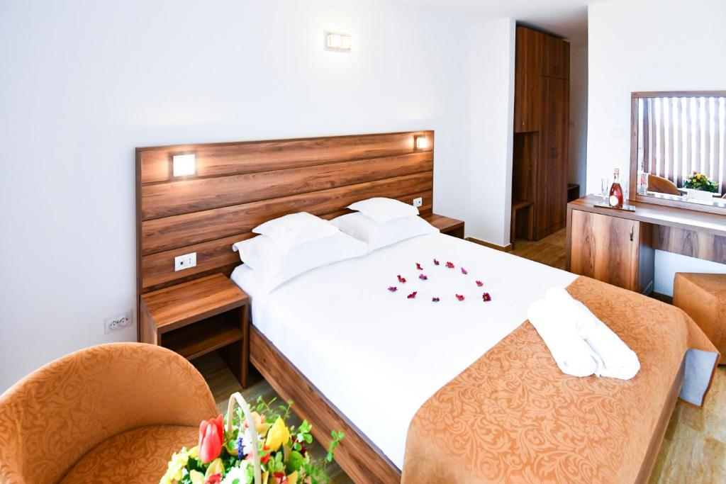 a bedroom with a large white bed and two chairs at COMPLEX TISMANA 3* ALL INCLUSIVE in Jupiter