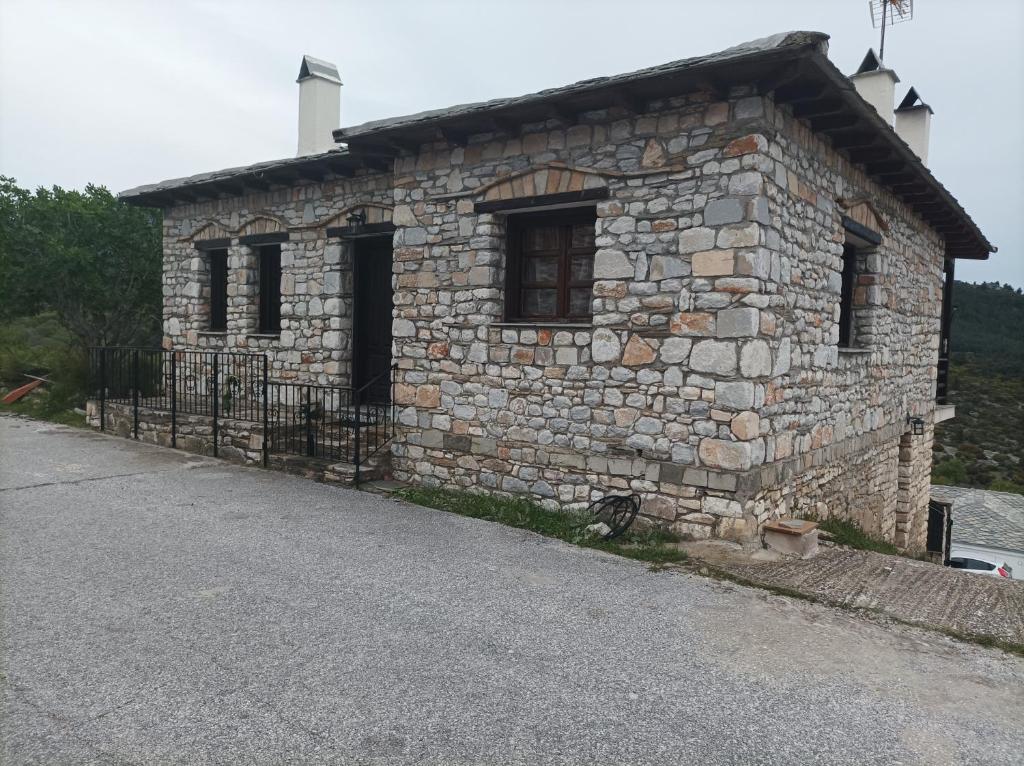 a stone building on the side of a road at Stelios house in Theologos