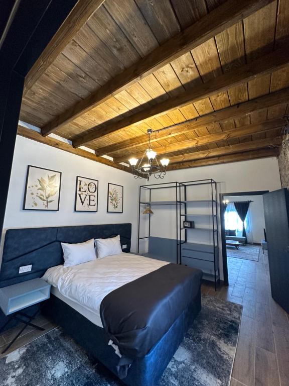 a bedroom with a large bed and a wooden ceiling at Konak lapta House in Kyrenia