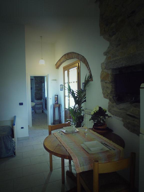 a dining room with a table and a mirror at Villa il Poderino in Marina di Campo