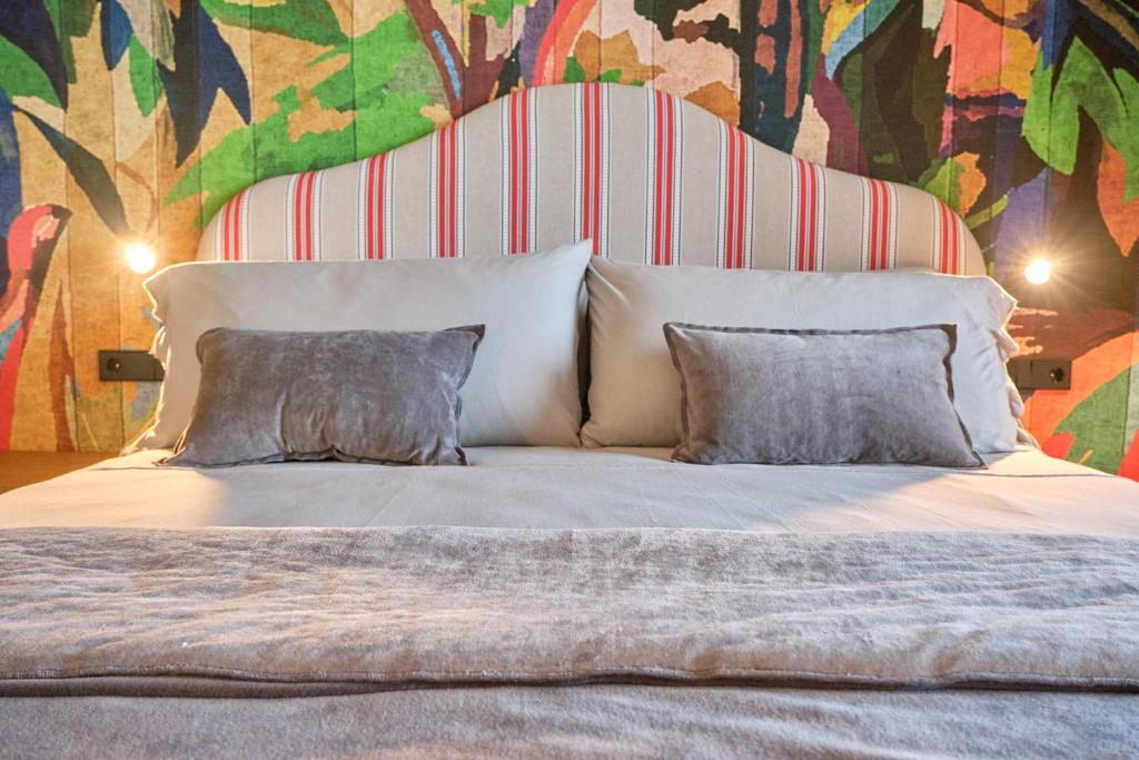 a large bed with two pillows in a bedroom at Casa Indiana Hotel Boutique in Blanes
