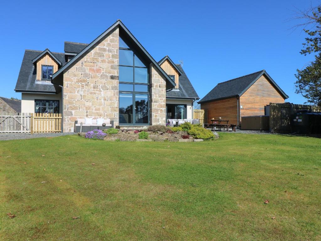 a house with a large lawn in front of it at Woodend Croft in Ellon