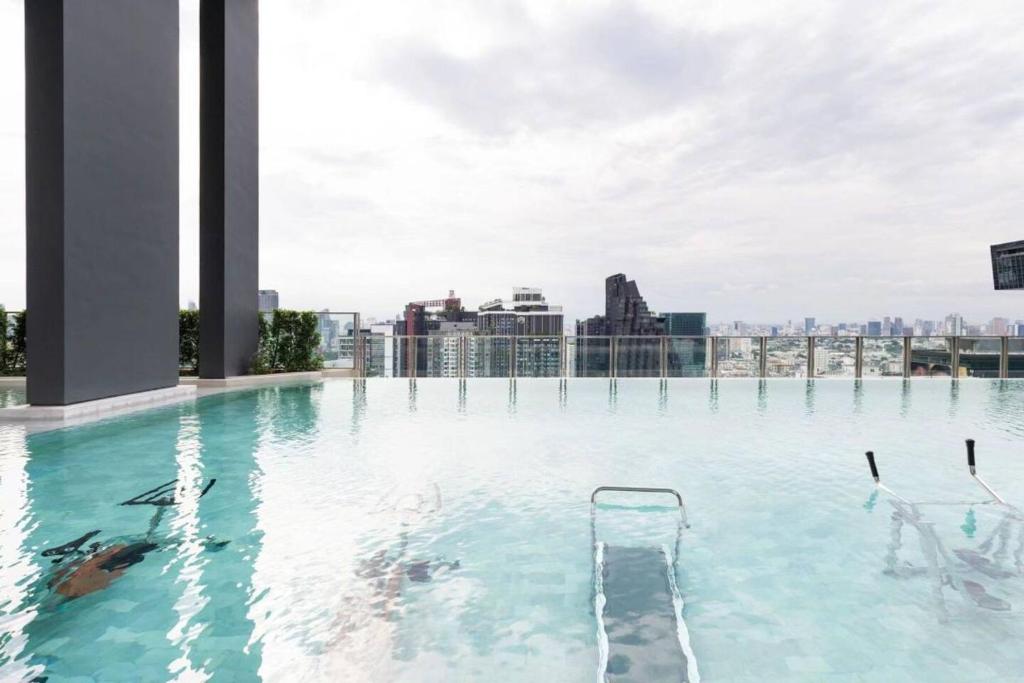 a swimming pool on the roof of a building at 4-mrt rame9 400m-Infinity pool/gym/shopping mall 