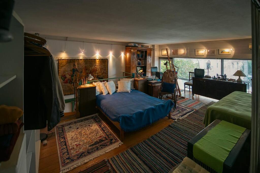 a bedroom with a bed and a living room at Architect Art Studio in Athens