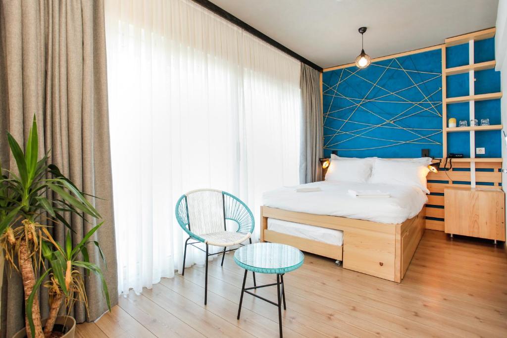 a bedroom with a bed and a chair and a table at Miller Hotel in Istanbul