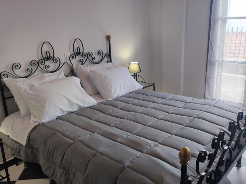 a bedroom with a large bed with white pillows at Fioravante in Argostoli