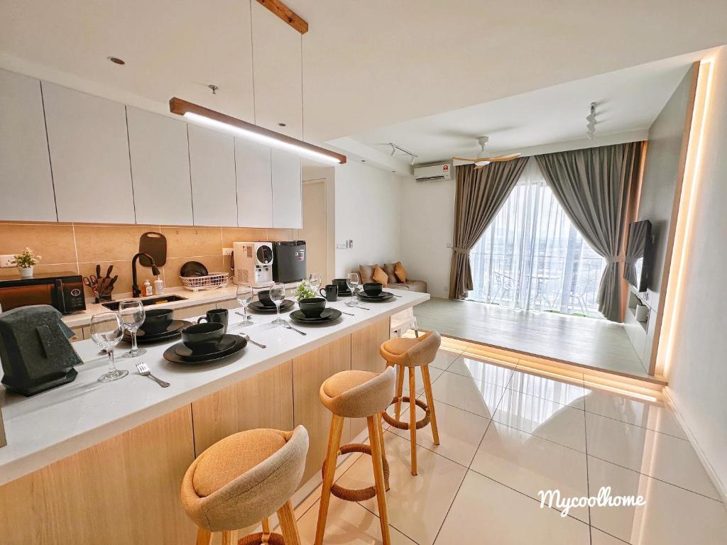 a kitchen with a counter and some stools at Sunway Onsen Hotsprings with Ipoh City View, Sunway Lost World in Ipoh