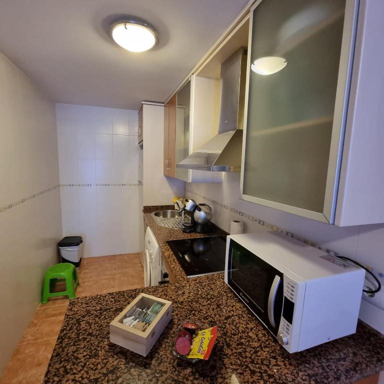 A kitchen or kitchenette at Ático dúplex con piscina privada en Vera Playa