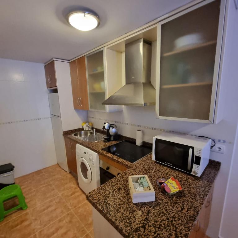 A kitchen or kitchenette at Ático dúplex con piscina privada en Vera Playa