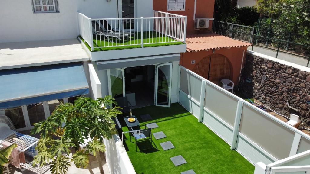 an overhead view of a balcony with green grass at New Garden Solarium Bungalow in Maspalomas