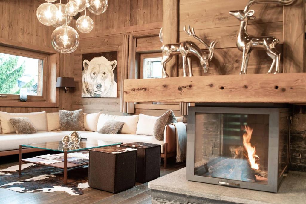 a living room with a couch and a fireplace at Le Chalet des Ours in Megève