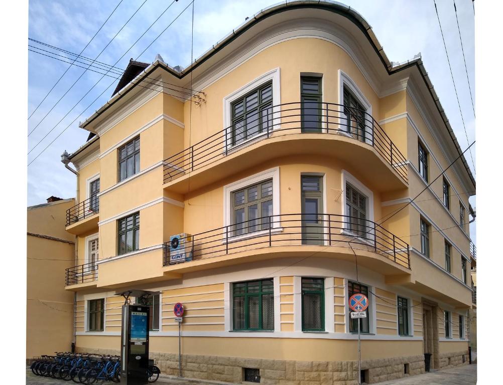 a yellow building with balconies on top of it at Mansarda in Cluj-Napoca