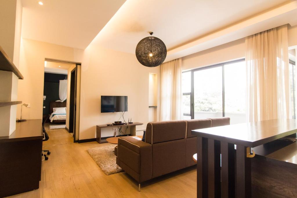 a living room with a couch and a television at Warwick Centre Furnished and Serviced Apartments in Nairobi