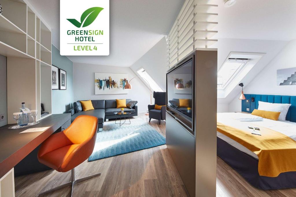 a bedroom with a bed and a living room at nestor Hotel Neckarsulm in Neckarsulm