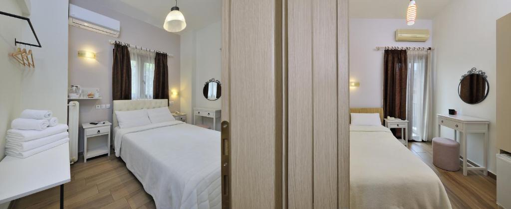 Posteľ alebo postele v izbe v ubytovaní Dryades & Orion Hotel