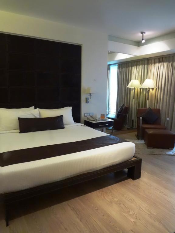 Postel nebo postele na pokoji v ubytování Mirage Hotel, Mumbai International Airport