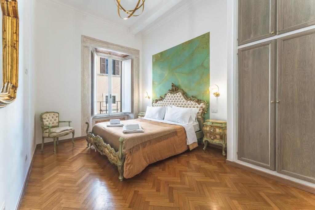 a bedroom with a bed and a painting on the wall at Palazzo Pamphili Lecca di Guevara in Rome